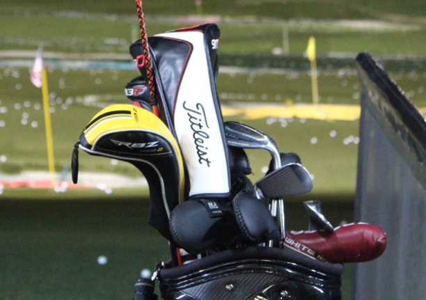 a golf bag with clubs inside