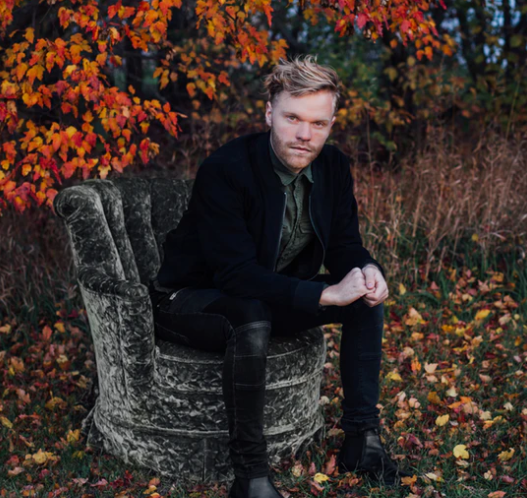 a man in a suit and autumnal tree