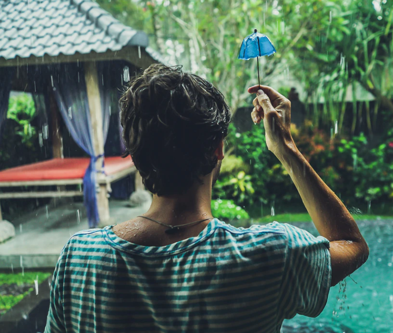 a man holding a tiny umbrella