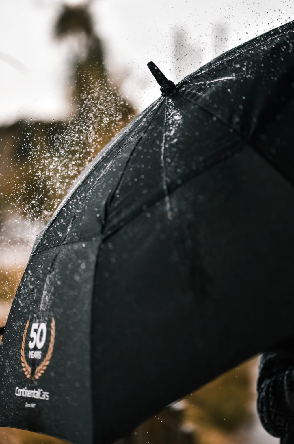 black umbrella with logo in the rain