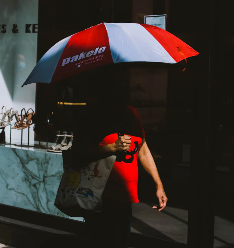 person with a branded umbrella