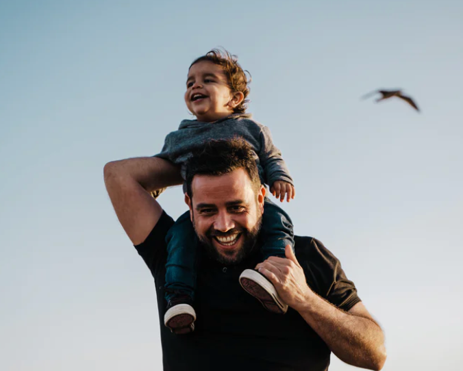 a child and father laughing