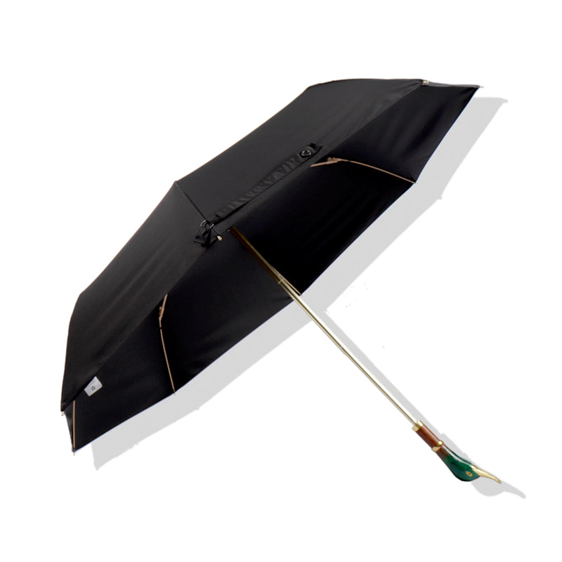 Black umbrella with a decorative duck's head handle on a white background